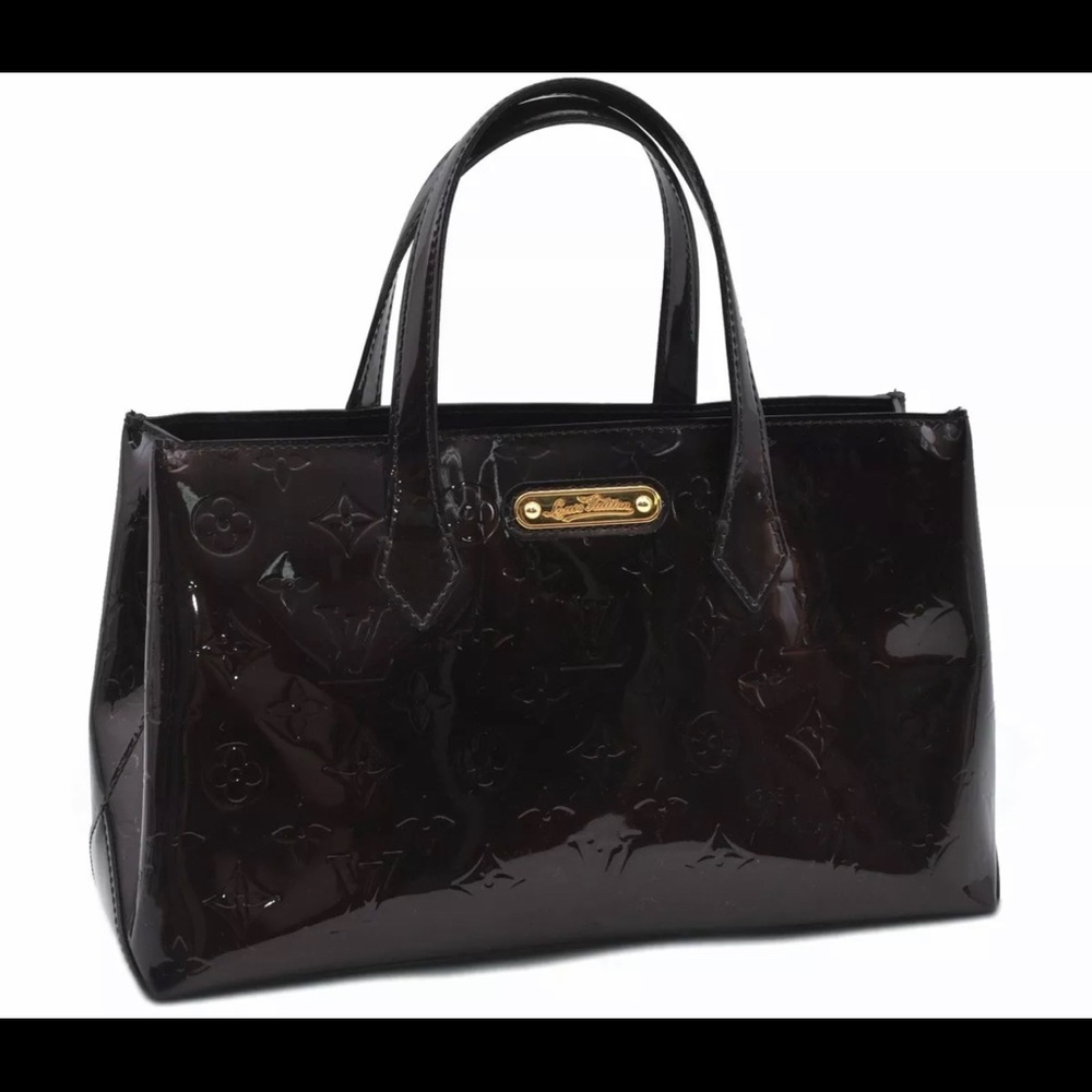 Louis Vuitton handbag bucket tote style, maroon in color